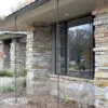 Side View of House with Natural Stone Pillars and Wainscoting