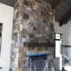 drystacked mortarless fireplace with earthy brown and grey real stone veneer