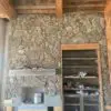 Natural thin stone veneer being installed on a fireplce