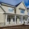 Home exterior with Chamberlain real thin stone veneer and tan mortar