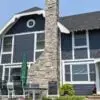 Dutch colonial house with Avondale natural thin stone veneer chimney