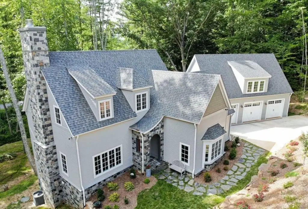 Birds eye view of home with Carlisle real stone veneer chimney, wainscoting, and front entrance