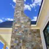 Exterior accent wall and chimney with Rochester and Whistler natural stone veneer