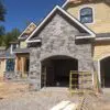 Garage siding with Berkley castle rock style natural stone veneer