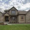 Custom Buckingham Natural Stone Veneer Exterior with Brown