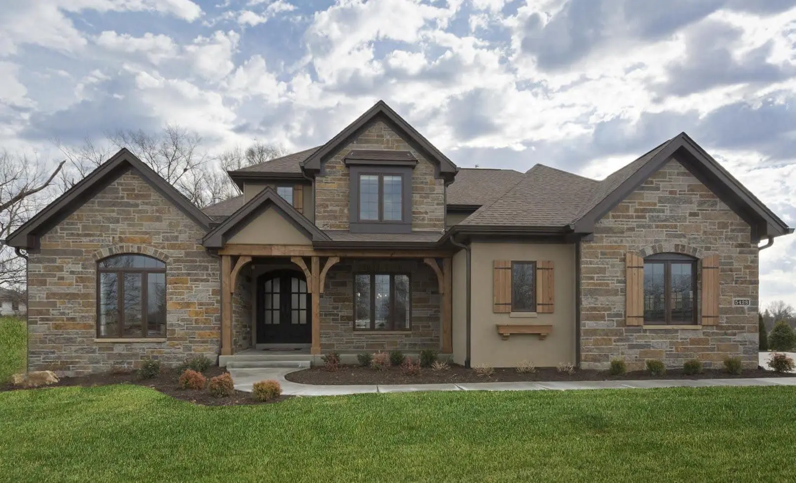 Custom Buckingham Natural Stone Veneer Exterior with Brown