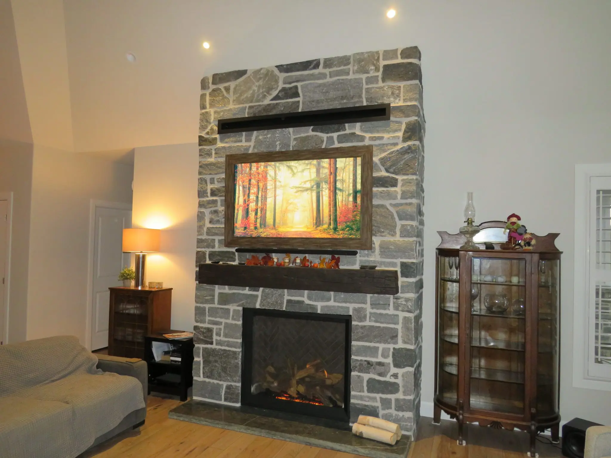 Timmins Real Stone Veneer with Custom Dark Pieces Interior Fireplace
