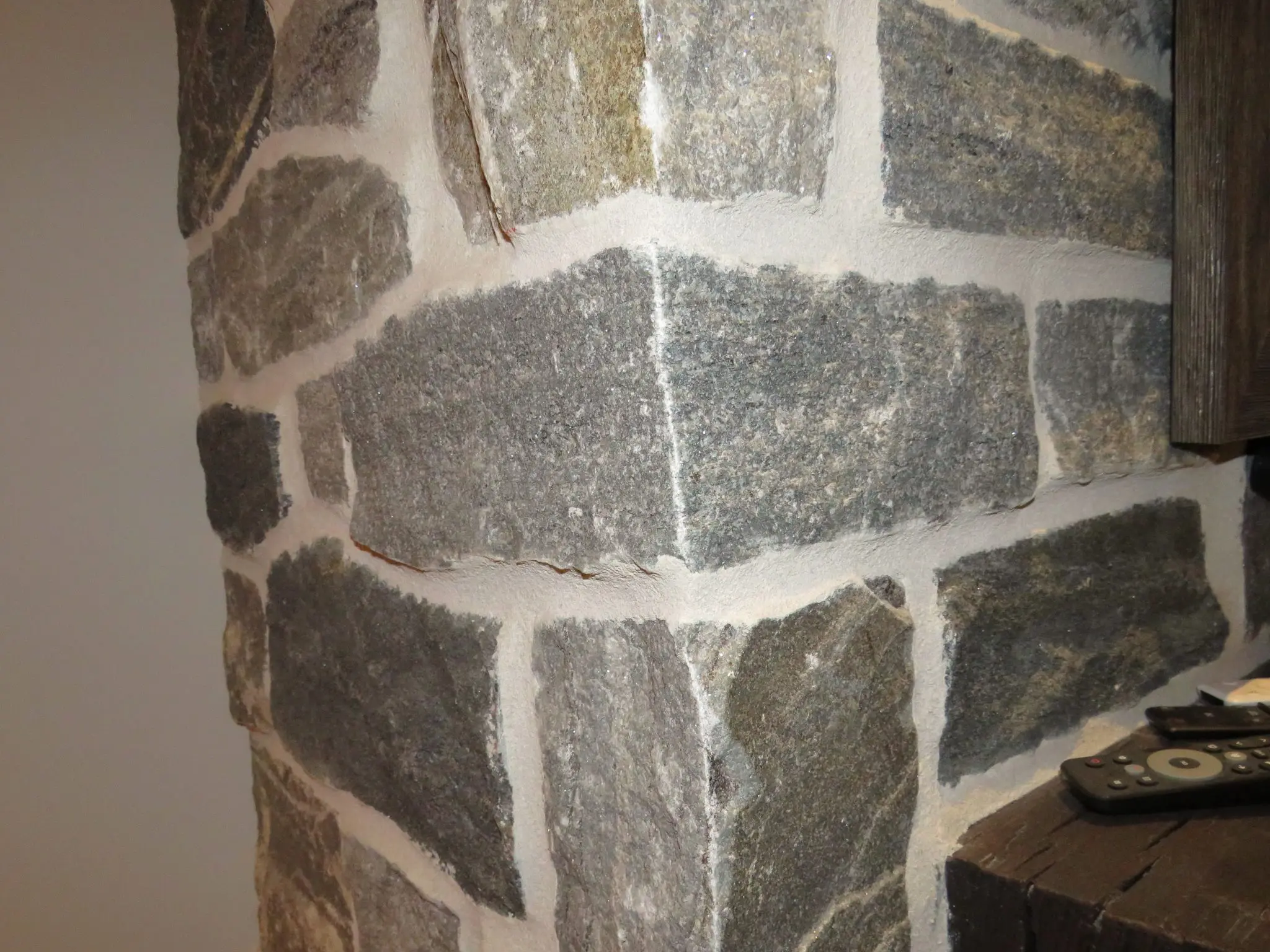 Timmins Real Stone Veneer with Custom Dark Pieces Living Room Fireplace Corners