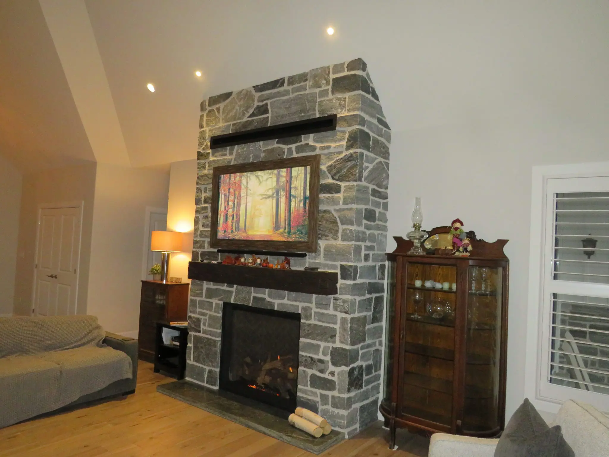 Timmins Real Stone Veneer with Custom Dark Pieces Living Room Fireplace