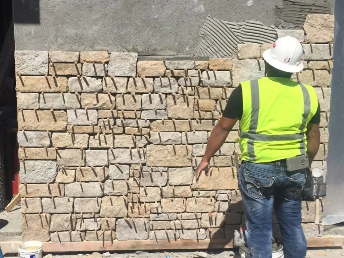 Custom Blend of Natural Stone Veneer Being Installed