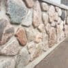 Wisconsin granite fieldstone natural thin veneer on an exterior wall