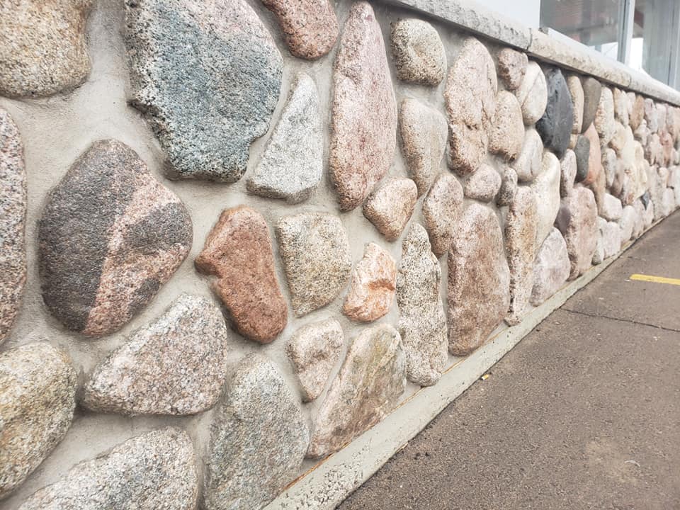 Wisconsin granite fieldstone natural thin veneer on an exterior wall