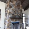 drystacked mortarless fireplace with earthy brown and grey real stone veneer