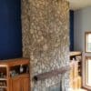 Side View of Living Room Fireplace Covered with Moss Rock Real Thin Stone Veneer