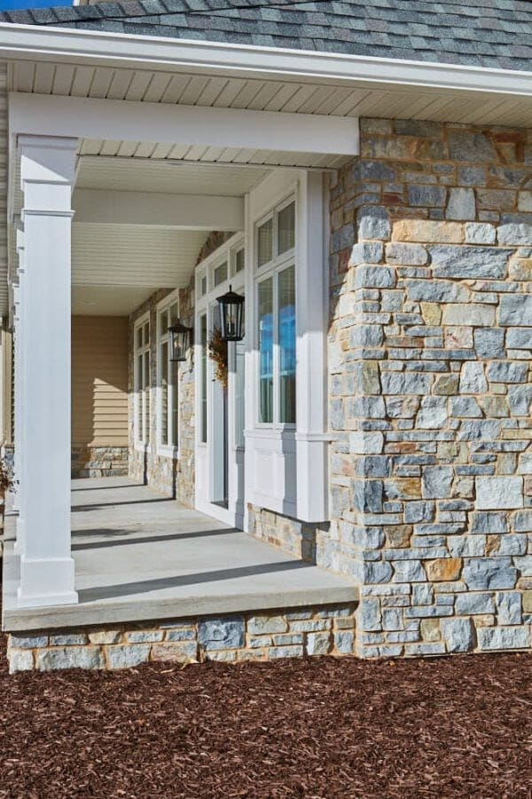 Home exterior with Chamberlain real thin stone veneer with tan mortar