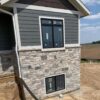 Exterior siding with Graphite natural stone veneer