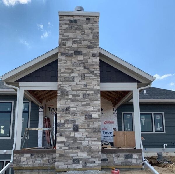 Covered patio and outdoor fireplace with Graphite real stone veneer