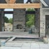 Covered patio and fireplace with Graphite black and gray ashlar style natural stone veneer