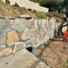 Close up of grey and tan stone on a retaining wall