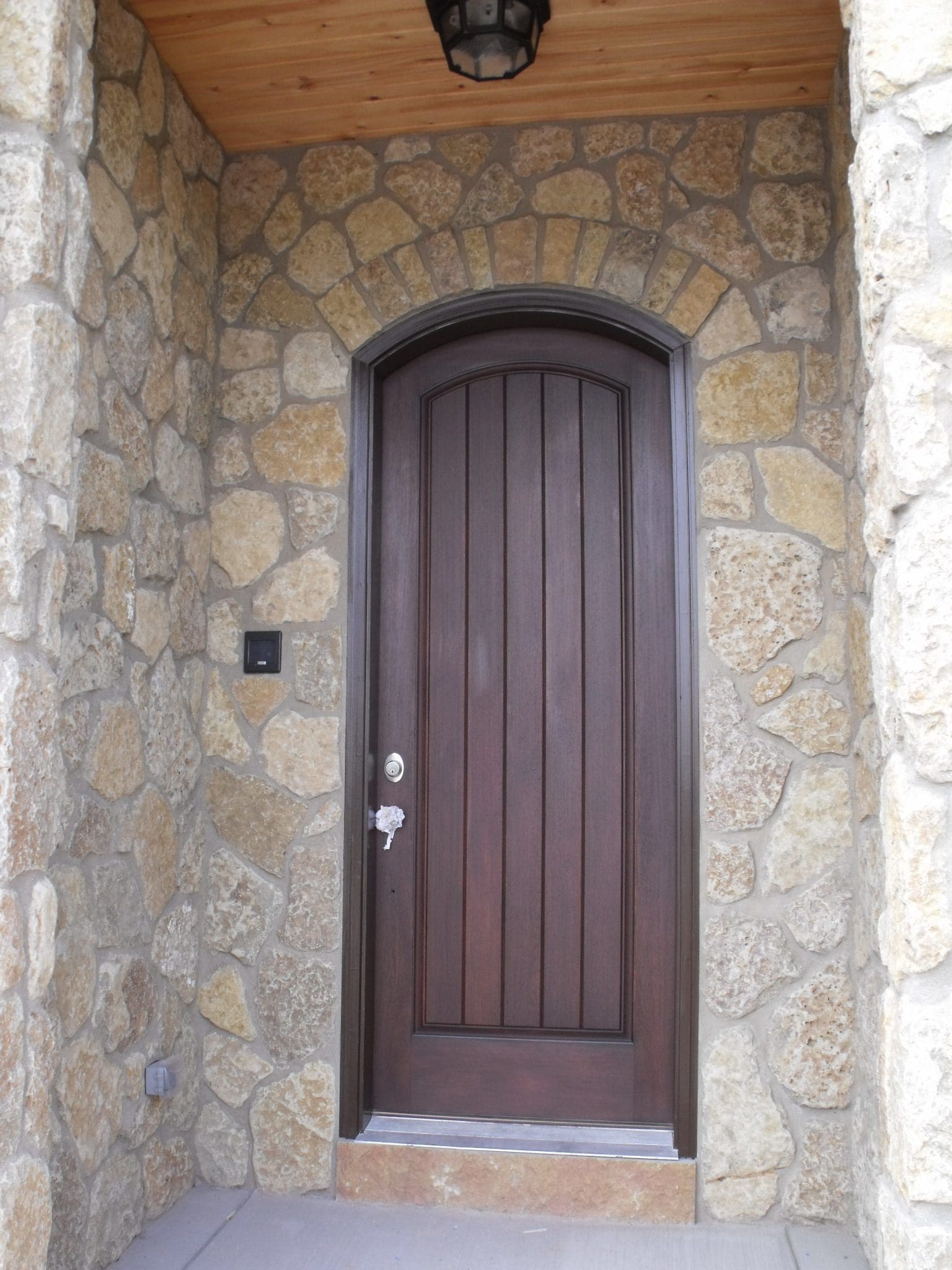 Front entrance with custom mosaic style tumbled Castle Ridge natural stone veneer