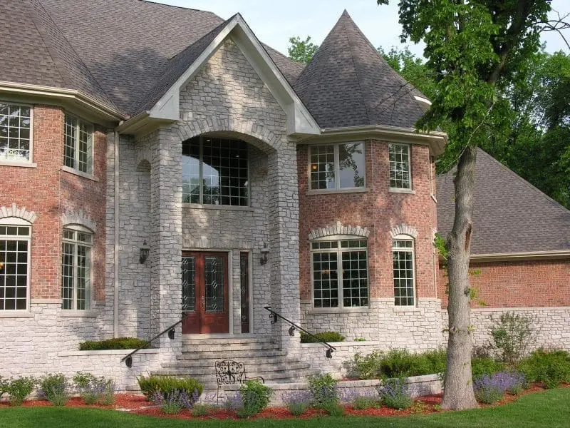 Exterior with Promenade tumbled real thin stone veneer