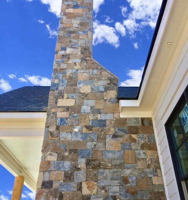 Exterior accent wall and chimney with Rochester and Whistler natural stone veneer