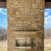 Covered patio and outdoor gas fireplace with Winfield natural thin stone veneer