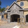 Garage siding with Berkley castle rock style natural stone veneer