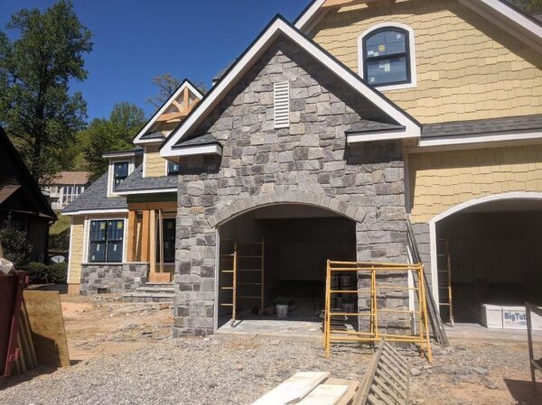 Garage siding with Berkley castle rock style natural stone veneer