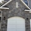 Garage siding with Berkley castle rock style real thin stone veneer