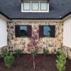 Exterior accent wall and wainscoting with Bonavista and Black Sands real stone veneer