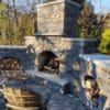Outdoor living wood burning fireplace with drystack Brighton real stone veneer