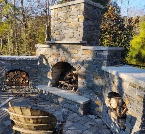 Outdoor living wood burning fireplace with drystack Brighton real stone veneer