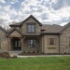 Custom Buckingham Natural Stone Veneer Exterior with Brown