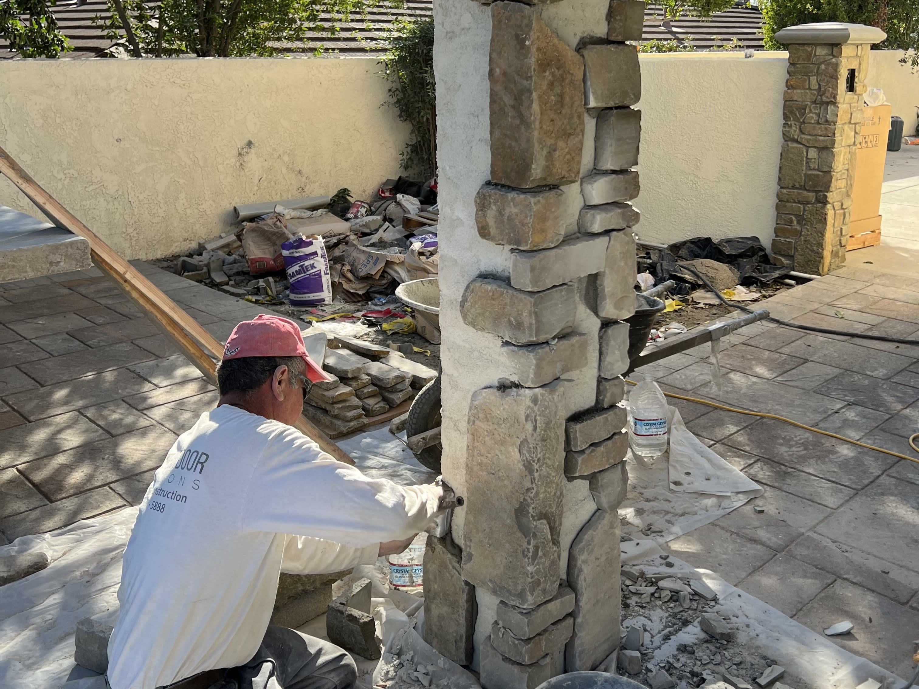 Professional Mason Installing Cabernet Natural Stone Veneer to Pillar