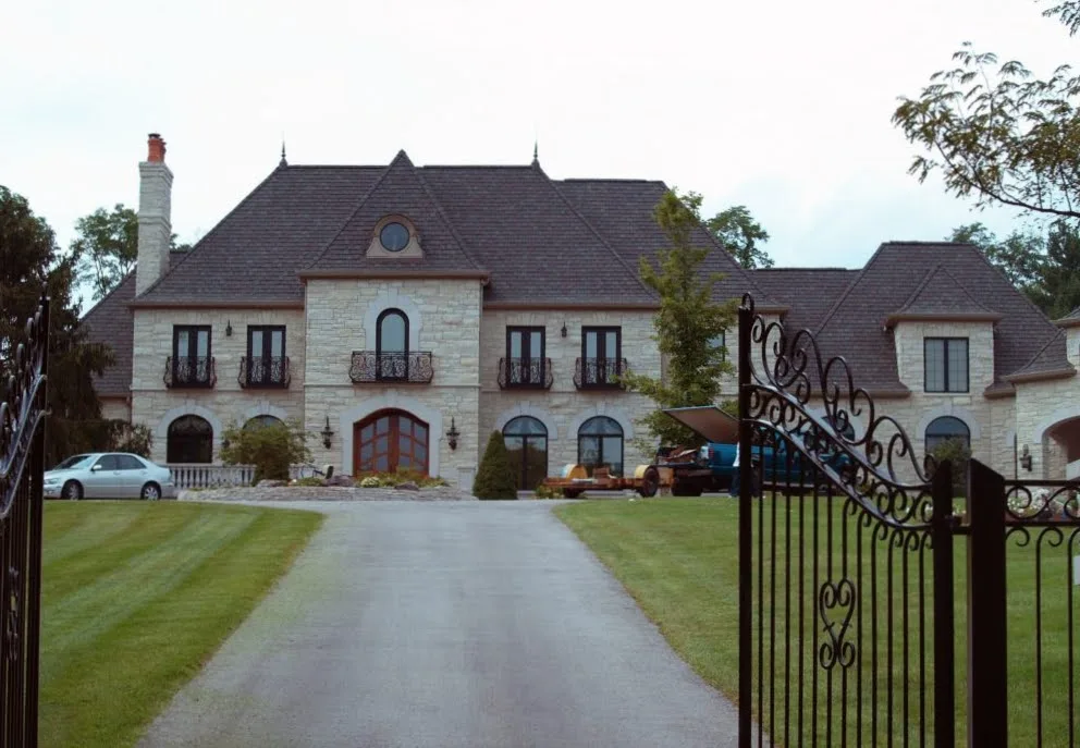 Custom La Spezia Natural Thin Stone Veneer Exterior with Gold Tones