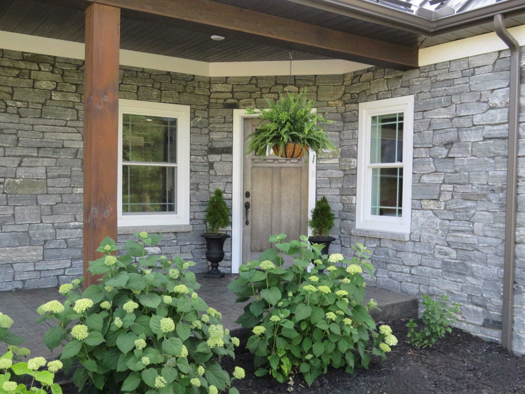 Logan Real Granite Thin Stone Veneer Custom Splitface Font Entrance with Dark Mortar