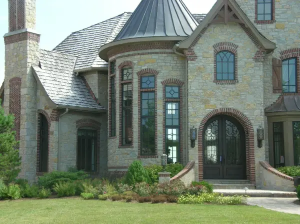 Castle Ridge and Promenade Blend Real Thin Stone Veneer Exterior with Brick