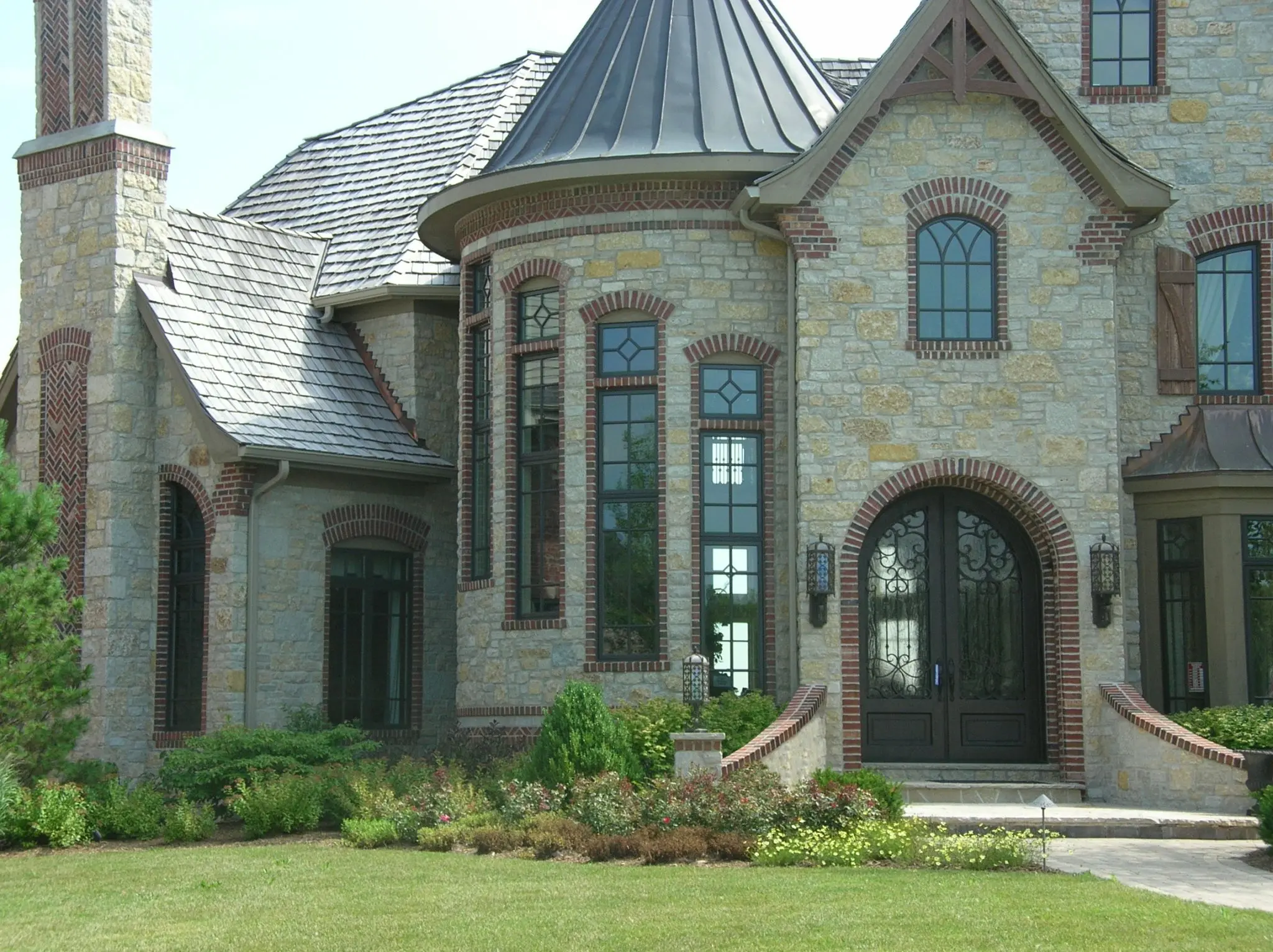 Castle Ridge and Promenade Blend Real Thin Stone Veneer Exterior with Brick