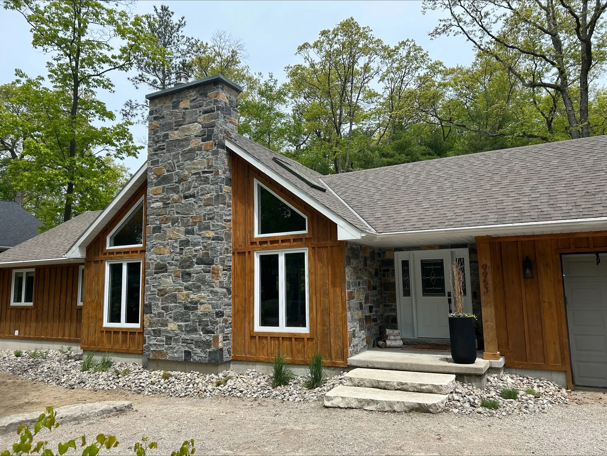 Custom Logan Natural Thin Stone Veneer with Dark Tones and Brown Chimney and Entrance