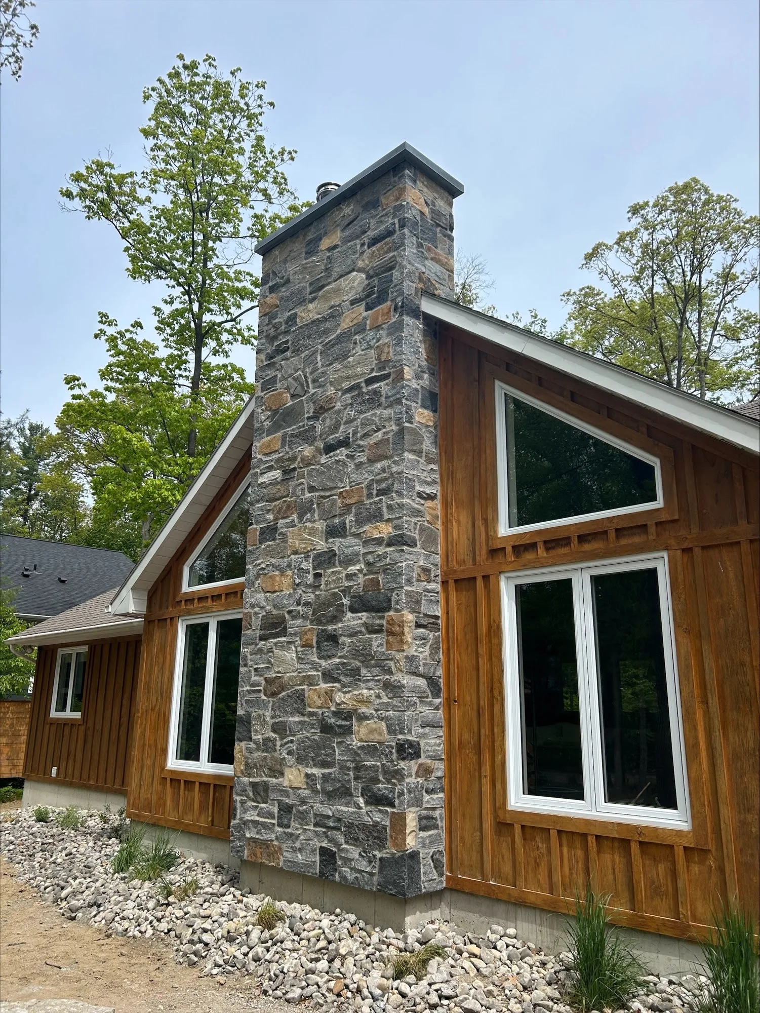 Custom Logan Natural Thin Stone Veneer with Dark Tones and Brown Chimney
