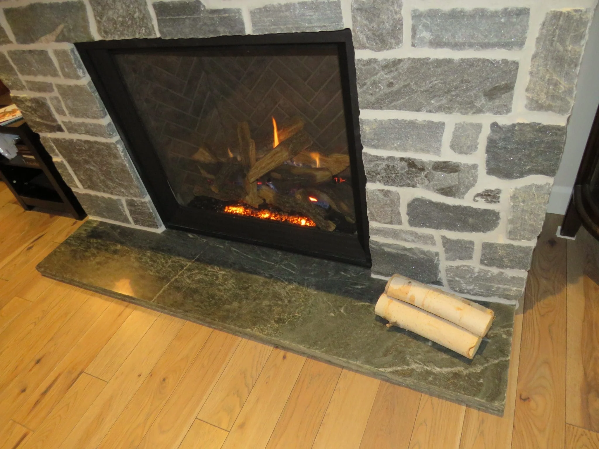 Timmins Real Stone Veneer with Custom Dark Pieces Living Room Fireplace Close Up