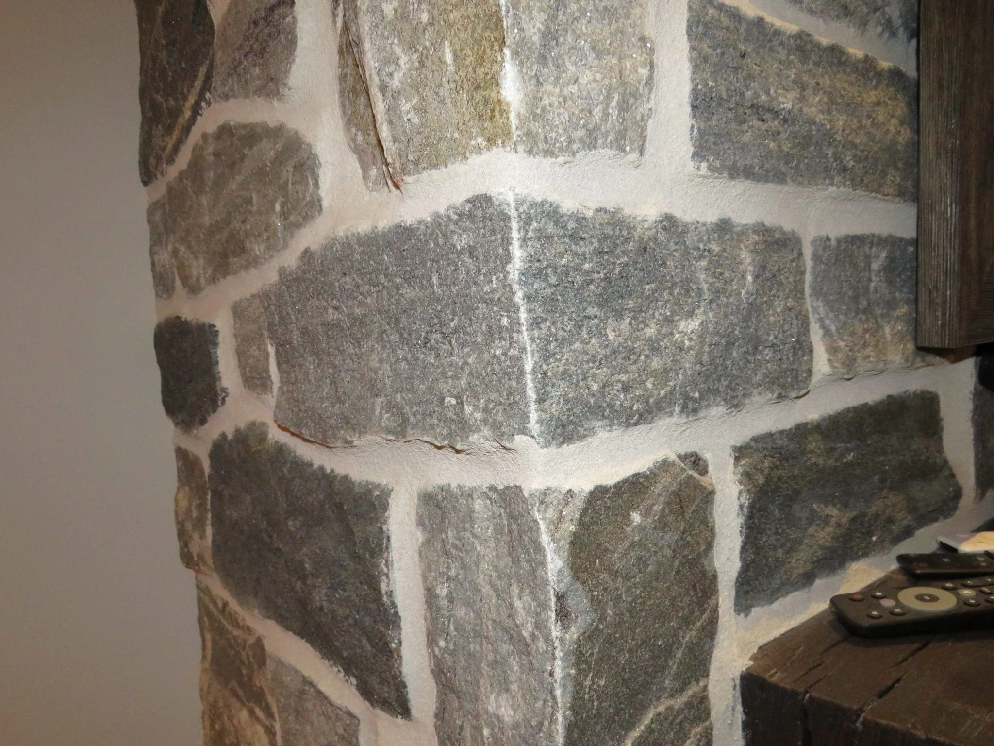 Timmins Real Stone Veneer with Custom Dark Pieces Living Room Fireplace Corners